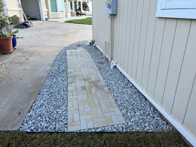 Paver walkway with a gravel border on a newer Prosper build